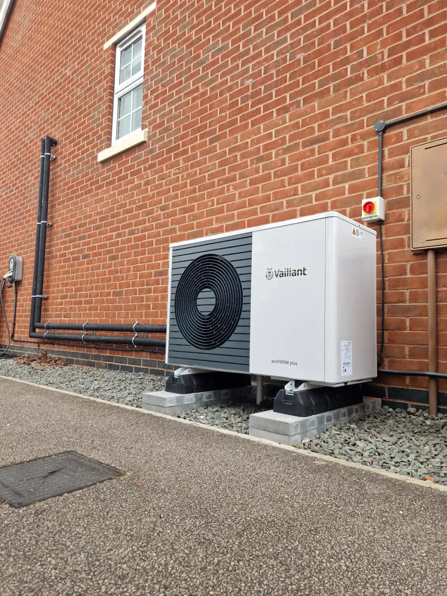 Vaillant aroTHERM heat pump installed against a brick wall