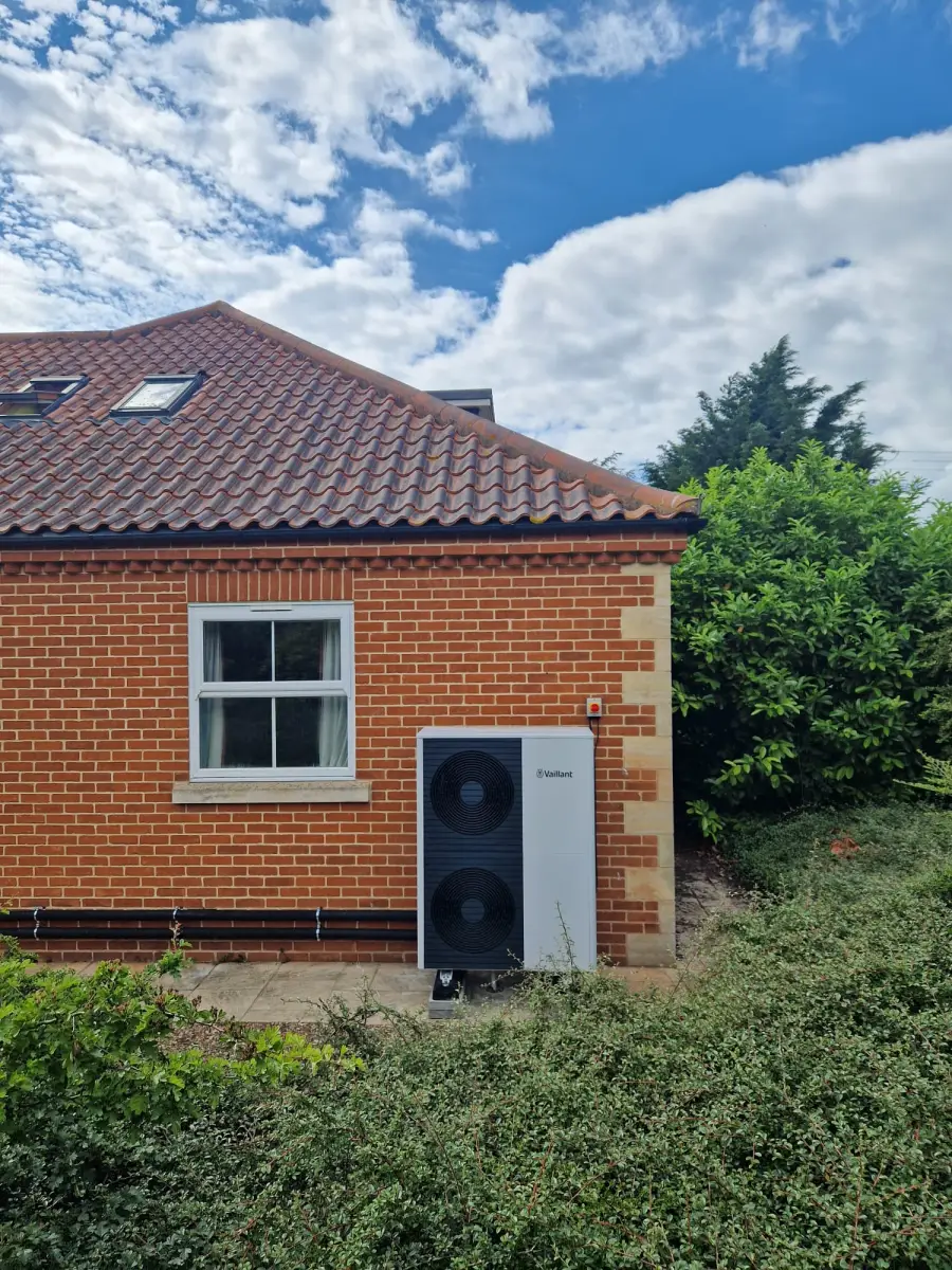 Vaillant aroTHERM Plus heat pump installed beside a house by Earth NRG