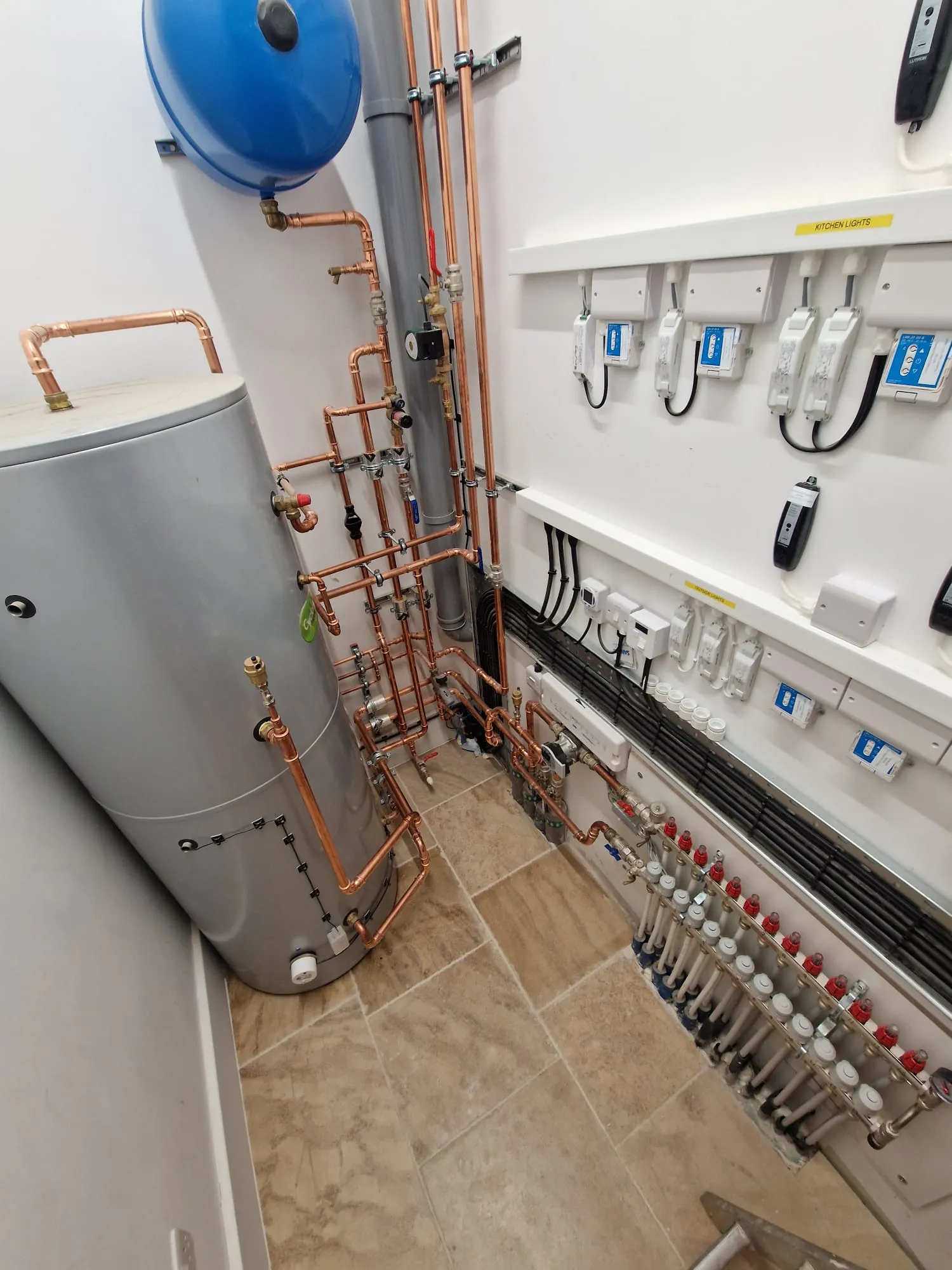 Plant room with cylinder, copper pipework, manifold and zone controls