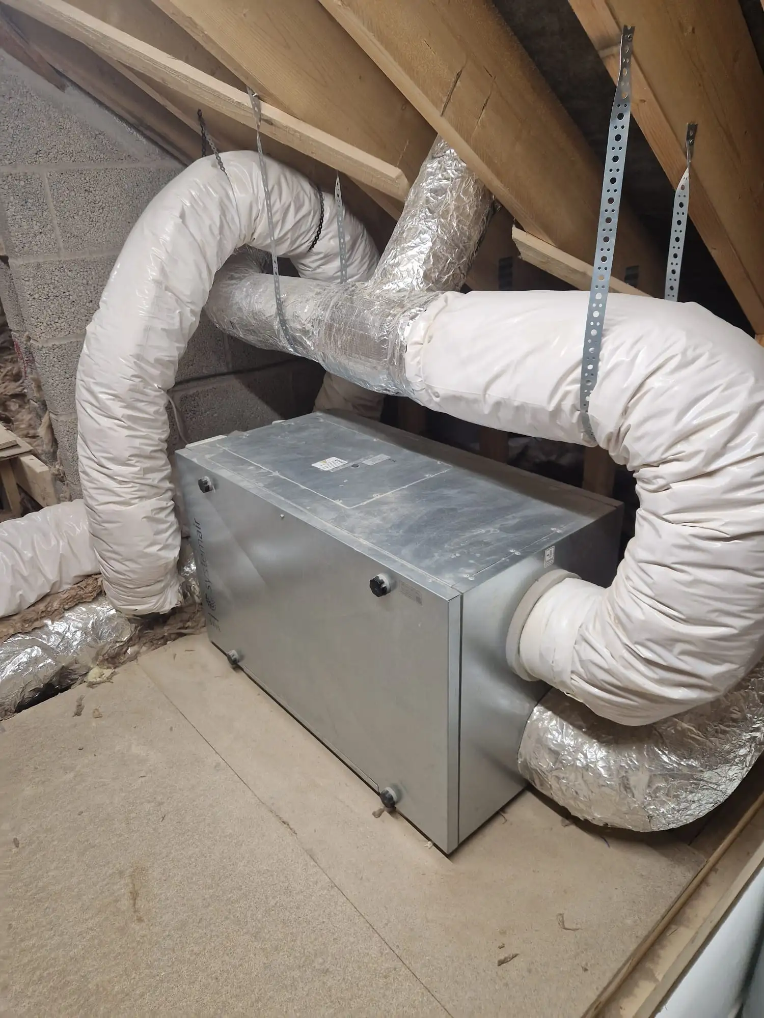 MVHR unit installed in a loft with insulated ductwork