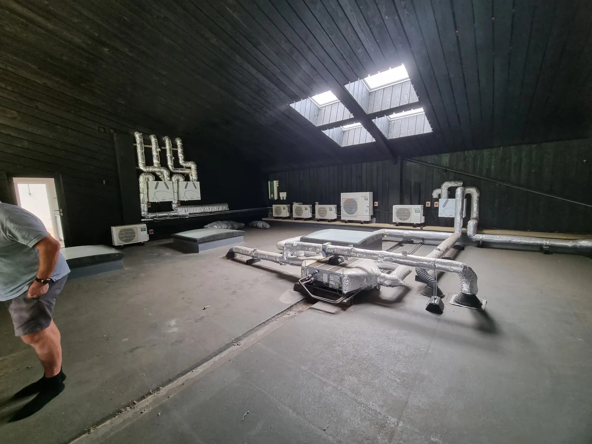 Large plant room with multiple heat pump and ventilation units